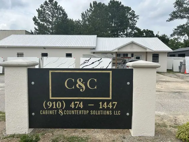 Black and gold C&C Cabinet & Countertop Solutions LLC sign with the phone number outside the Rockingham store